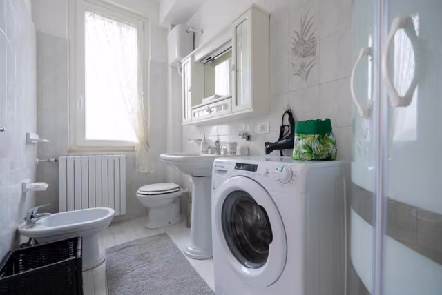 Bagno bianco con lavatrice del B & B L'ABBRACCIO
