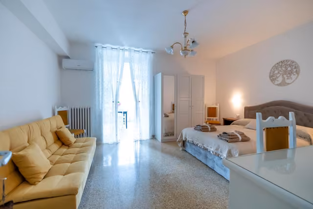 Soggiorno con divano e letto del B & B L'ABBRACCIO ad Agnone